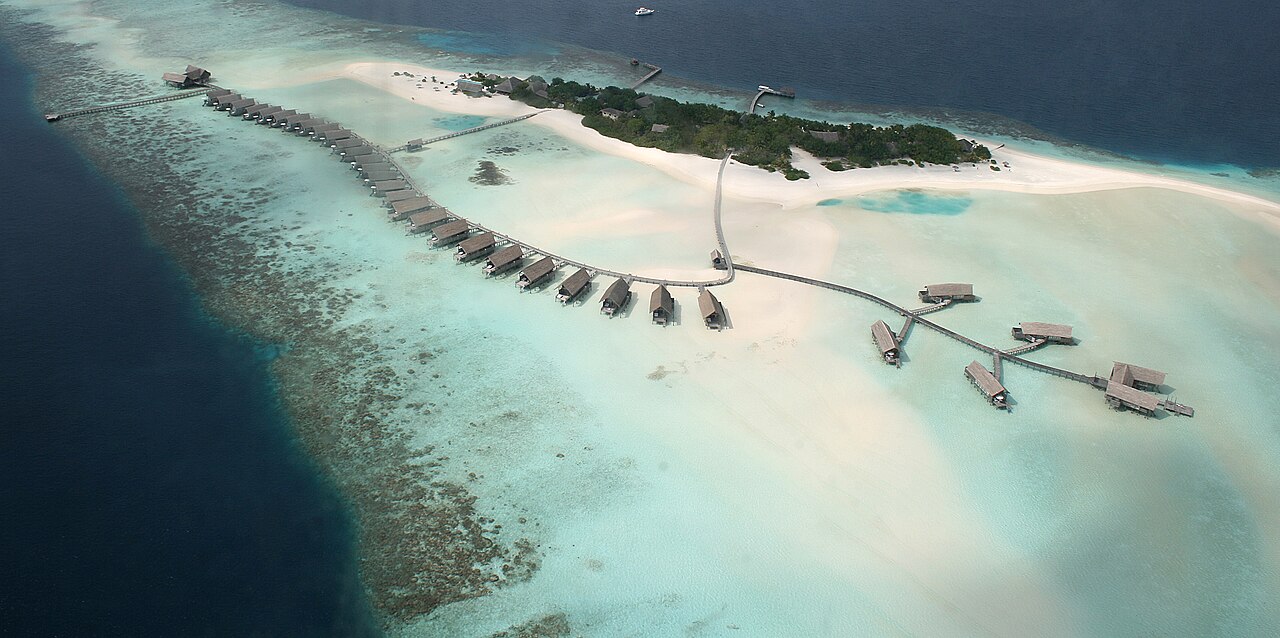 Aerial shot of a small island on a coral reef in the Maldives